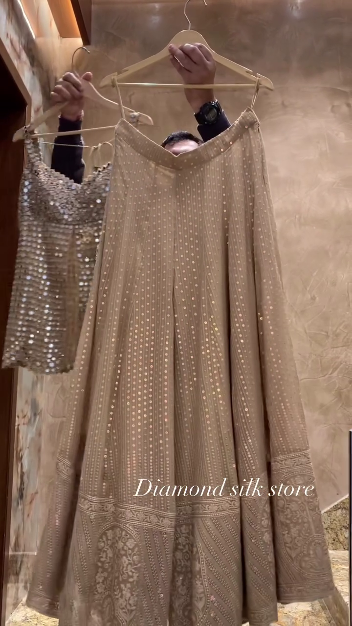 Champagne Mirror‑Work Sleeveless Long Top with Front Slit and Coordinated Flowing Skirt Contemporary Festive Set” ✨