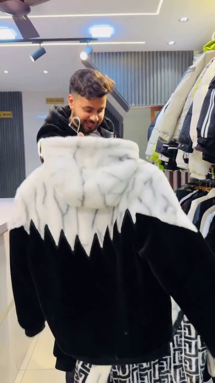 Black & White Faux‑Fur Zip‑Up Winter Jacket with Geometric Panel Detailing and Badge Accent for Men” 🖤🤍