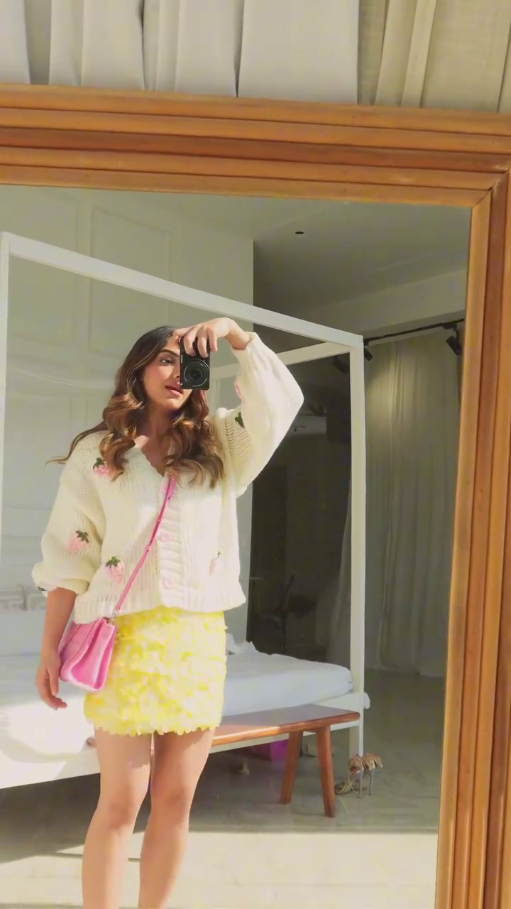 Cream Floral‑Detail Knit Cardigan with Yellow Textured Ruffle Mini Skirt and Pink Crossbody Vacation Outfit” 🌼