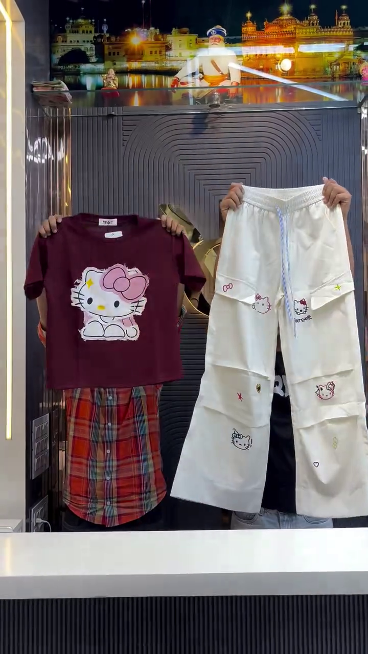 Red Short-Sleeved Hello Kitty Graphic Shirt Paired with White Pants Featuring Multiple Hello Kitty Prints, Stars, Hearts, and Bows Playful Character-Themed Ensemble ❤️👕👖🎀✨