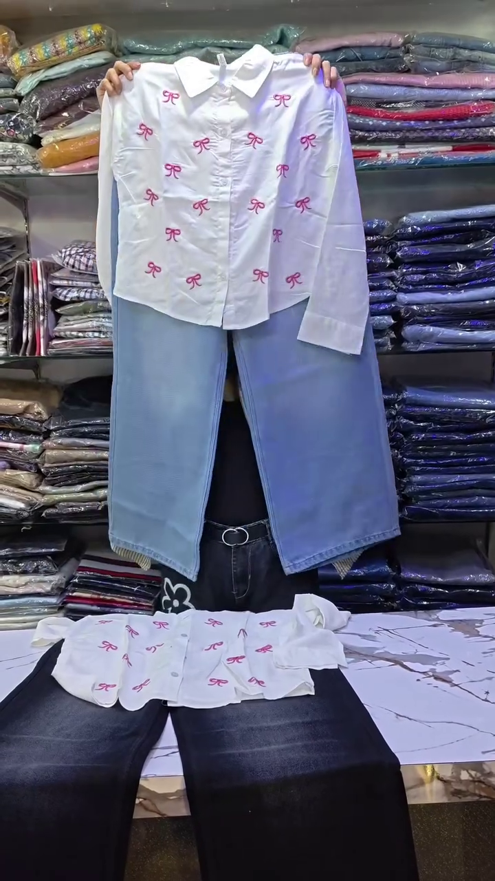 White Long-Sleeved Shirt with Pink Bow Designs Paired with Dark Blue Wide-Leg Jeans Casual Playful Ensemble 🤍👕🎀👖✨